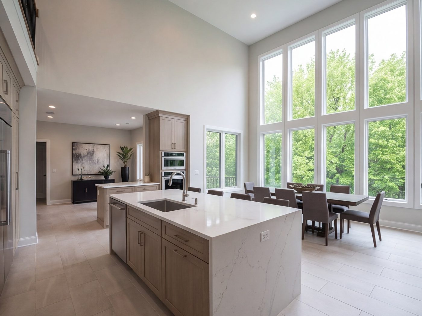 Large kitchen and dining area with one island and a wall of windows